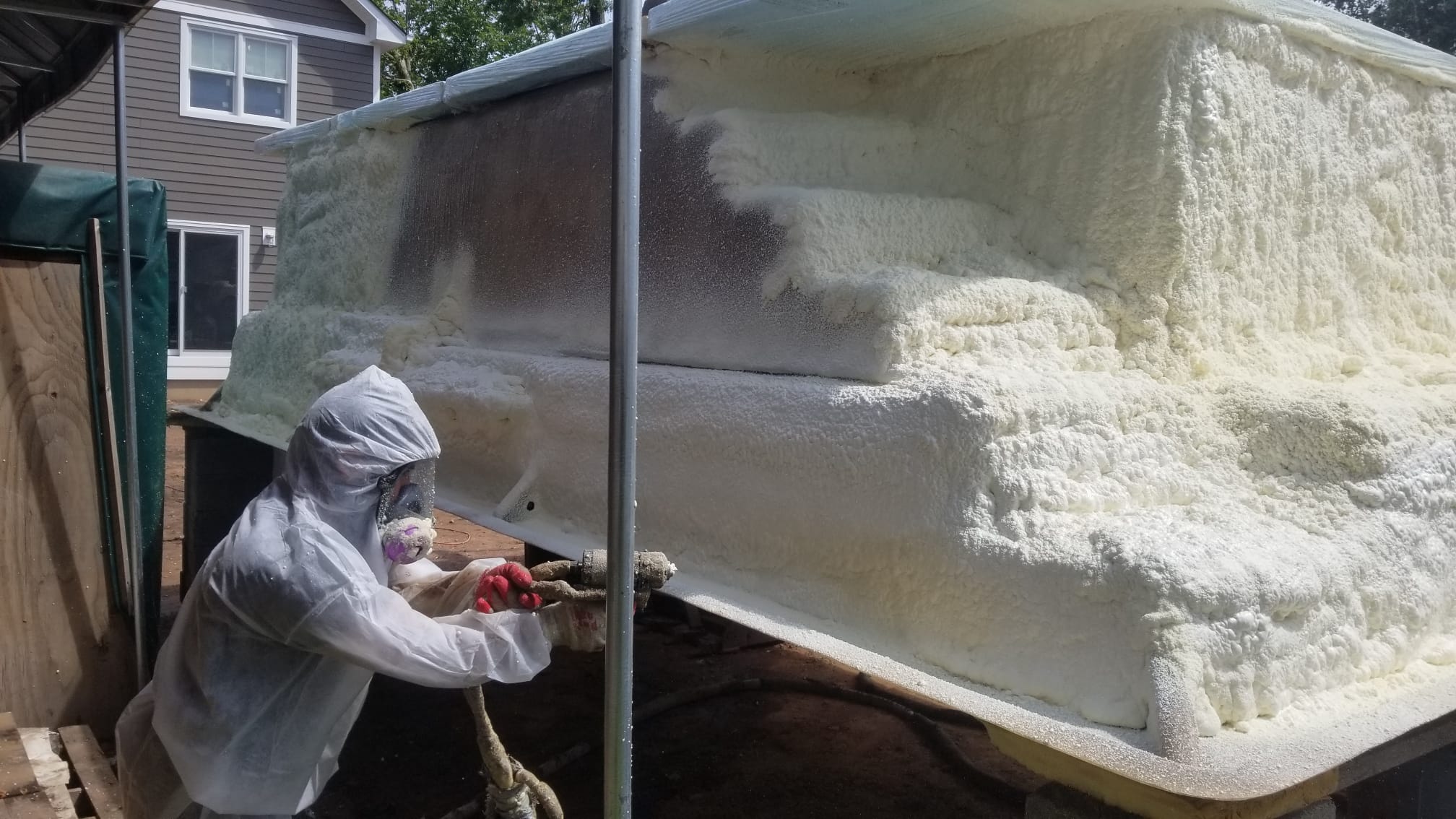 Spraying foam onto the underside of a large shell